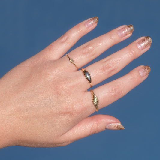 solid gold nails on a hand with ombre gold glitter nail art