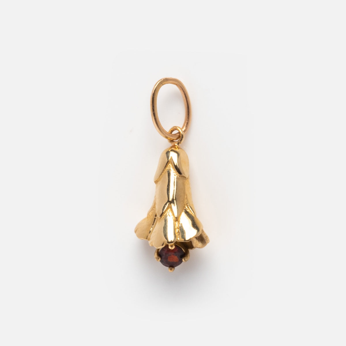 The Solid Gold Birth Flower Bud Charm is shaped like a bellflower with a small red gemstone at the base and a top loop for jewelry attachment, displayed on a plain white background.