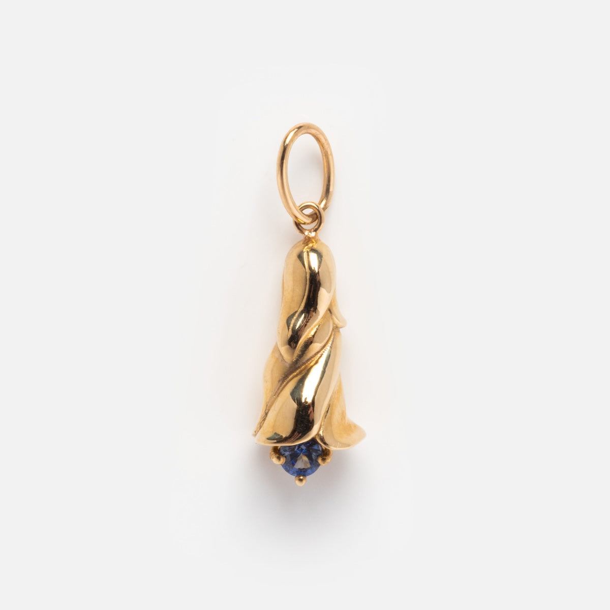 The Solid Gold Birth Flower Bud Charm features curved petals and a small blue gemstone at the tip, creating an elegant, personalized jewelry piece displayed against a plain white background.
