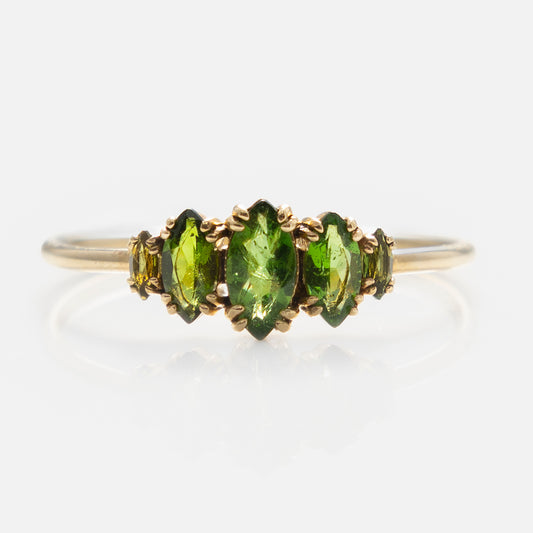 The Solid Gold Essential Marquise Cluster Ring features five marquise-cut green tourmalines set side by side with delicate prongs, displayed on a plain white background.
