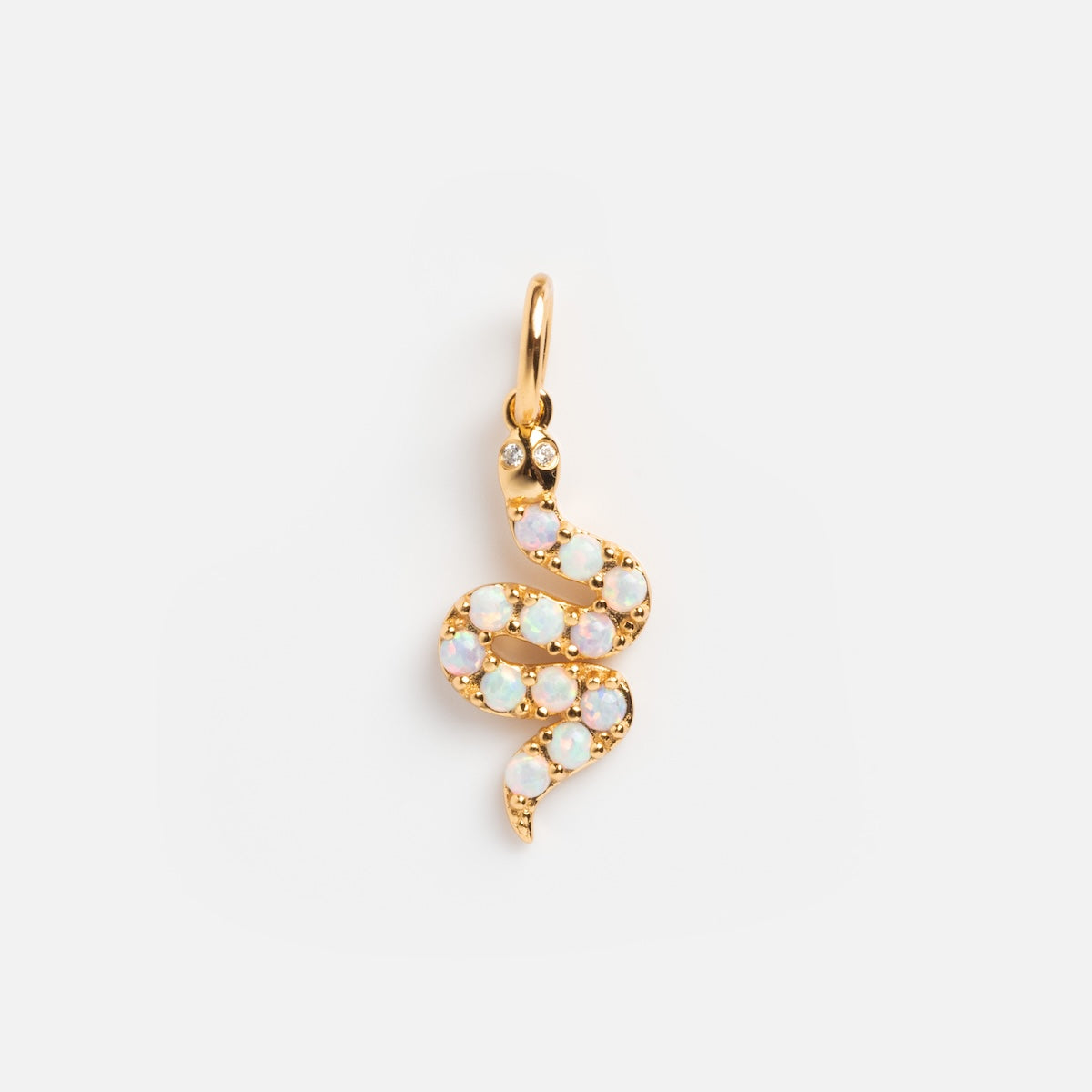 Charms by La Kaiser: An 18k gold vermeil snake-shaped pendant adorned with lab-created opal charms along its body and two white stones for eyes, shown on a plain white background.