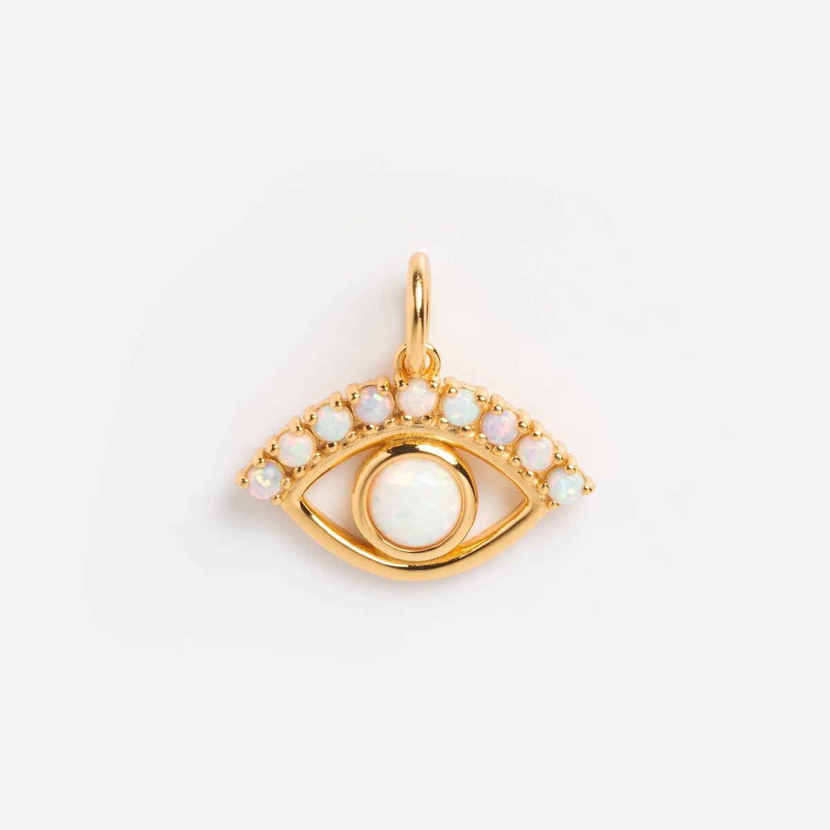 The Charms by La Kaiser pendant, in 18k gold vermeil, showcases an eye shape with a central round lab-created opal charm as the iris and smaller opals on the upper curve, displayed on a plain white background.