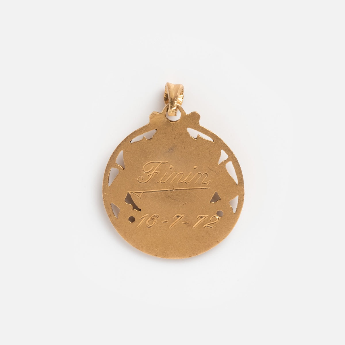 This Vintage 18k Openwork Mother Mary Coin Charm is a round gold pendant with cut-out details, engraved Finin and dated 16-7-72, featuring a small loop at the top for attaching to a chain.
