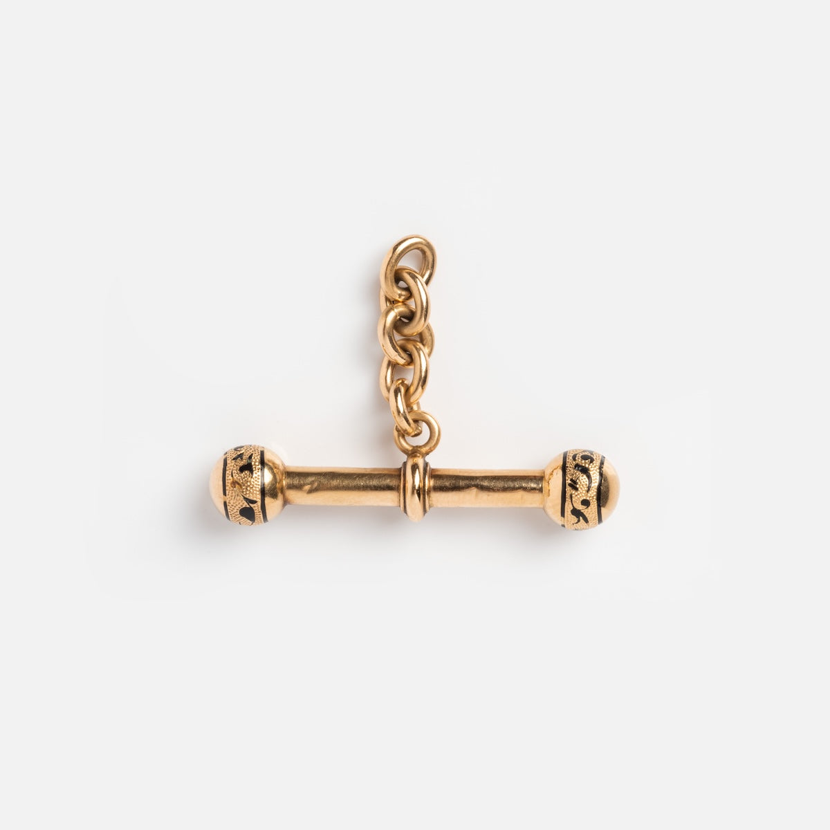 The Vintage 18k French T-Bar Dangle Charm showcases a gold chain link with engraved patterns at both ends, displayed against a plain white background, embodying the timeless elegance of solid yellow gold vintage jewelry.