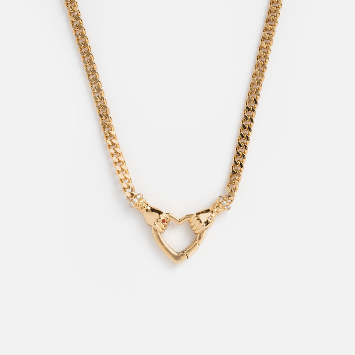 The Hand Over Heart Charm Holder Necklace in 14k gold vermeil features two hands forming a heart at the center with delicate accents, shown on a plain white background.