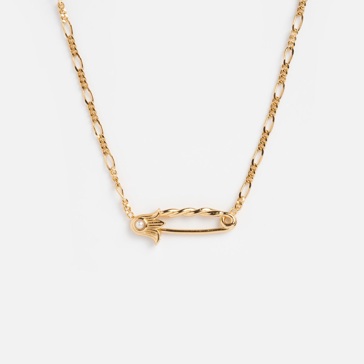 The Sonnet Safety Pin Charm Holder Necklace features an ornate, period-inspired pendant with a small clear gemstone accent on one end, shown on a white background.