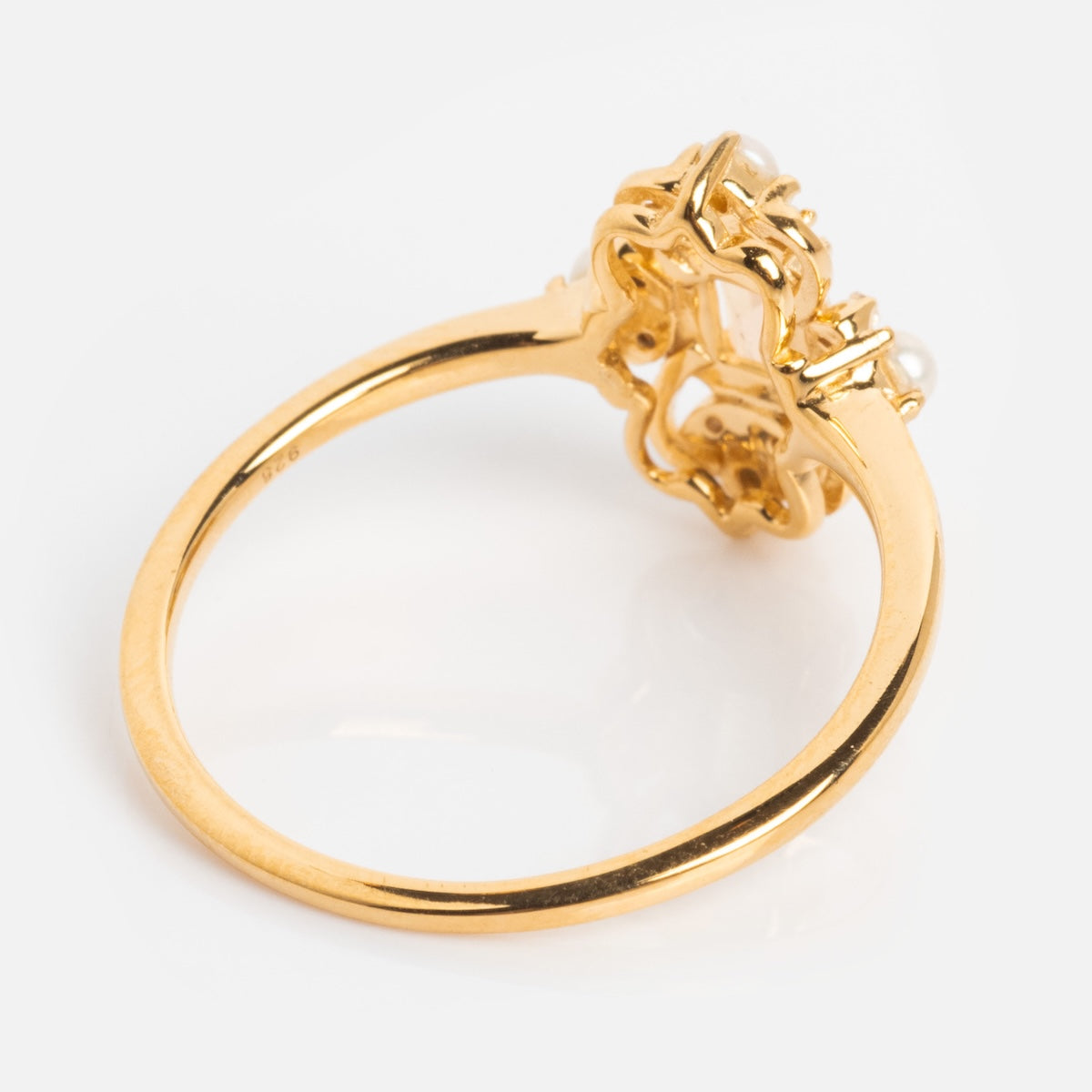 The Crown Jewel Opal and Pearl Ring features a decorative flower-shaped 14k gold vermeil setting, intricately designed to evoke vintage elegance, shown from the side on a plain white background.