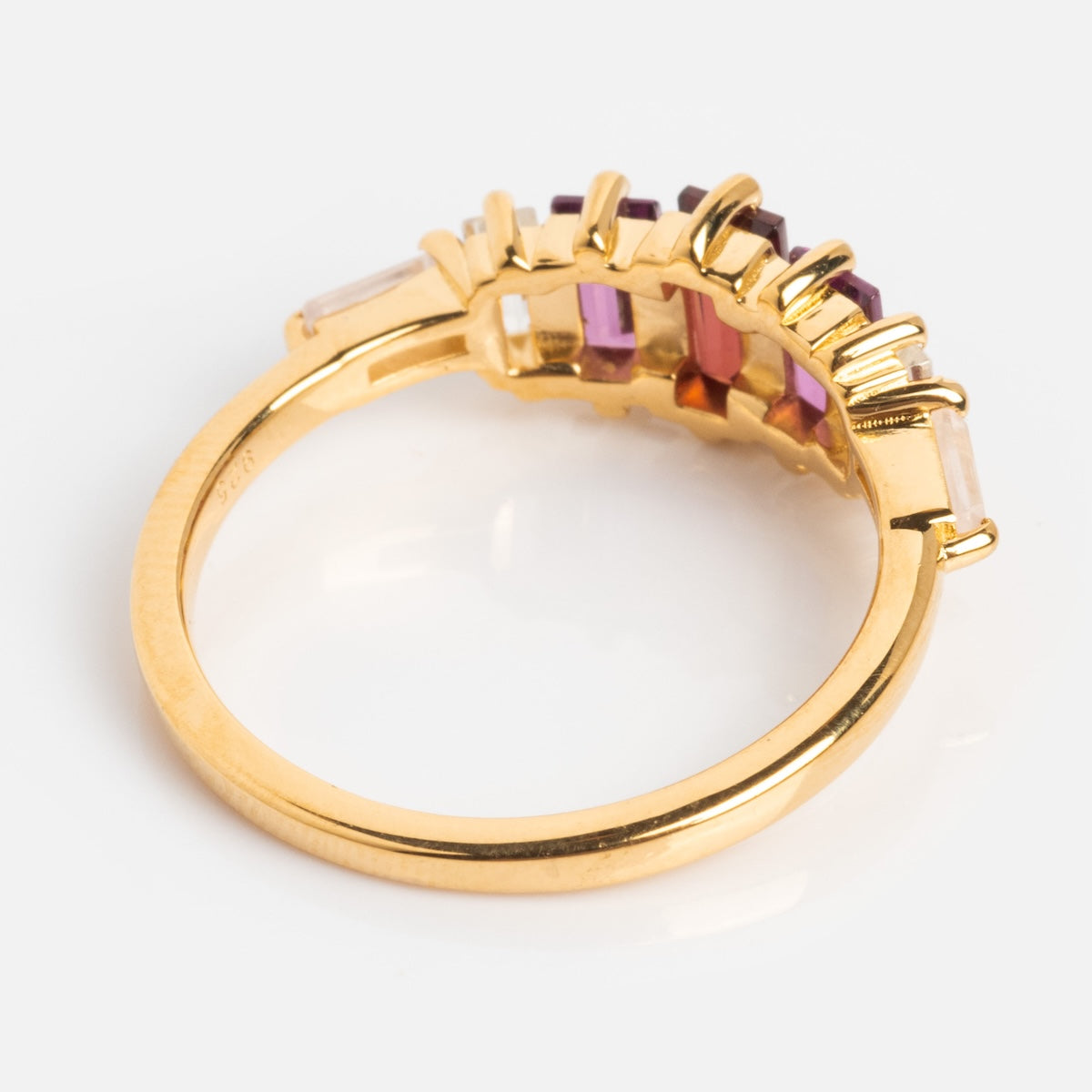 The Berry Baroque Garnet Crown Ring is a gold vermeil art deco piece with rectangular multicolored gemstones—purple, red, and orange—set in a crown-like row, displayed on a plain white background.