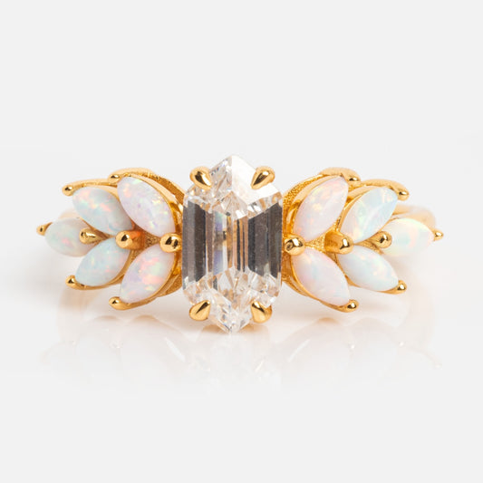 The Pink Opal Ombre and Topaz Lotus Ring showcases a central emerald-cut clear gemstone, accented with marquise-shaped pink opals in a leaf-inspired design, all set in 18k gold vermeil for an elegant, refined finish.