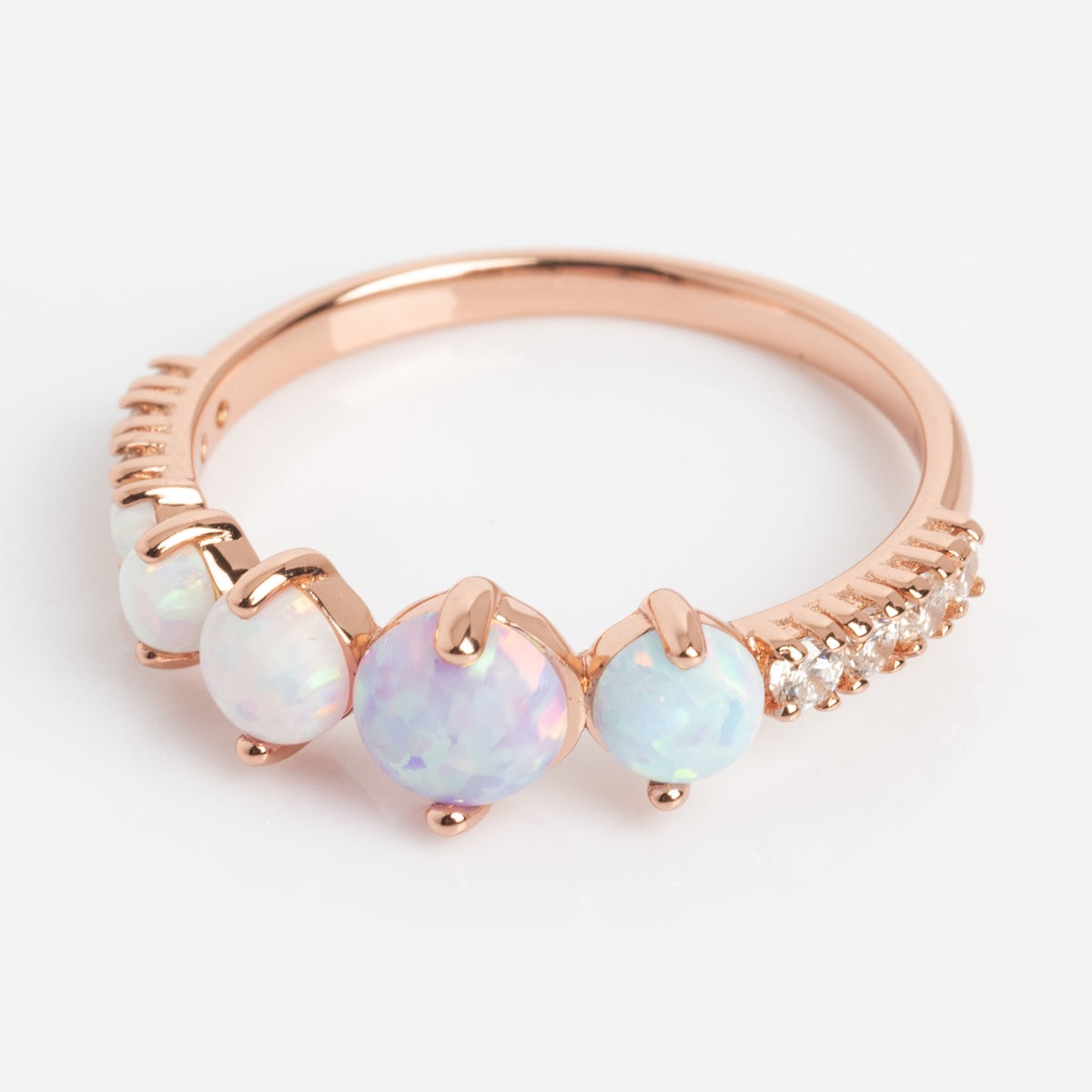 The Pastel Opal Shooting Star Ring is a rose gold vermeil ring with four round opals in varying sizes and a row of small white accent stones on one side, shown against a white background.