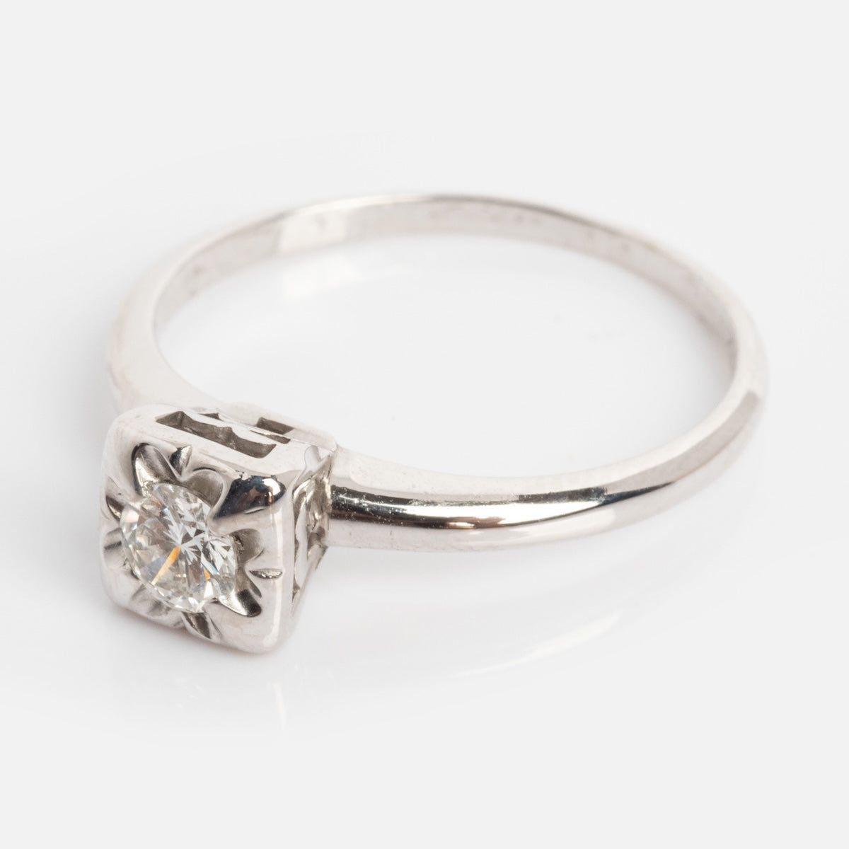 Vintage 14k 1940’s white gold ring, size 7, features a square-set diamond in an elegant band, showcased on a plain white background.