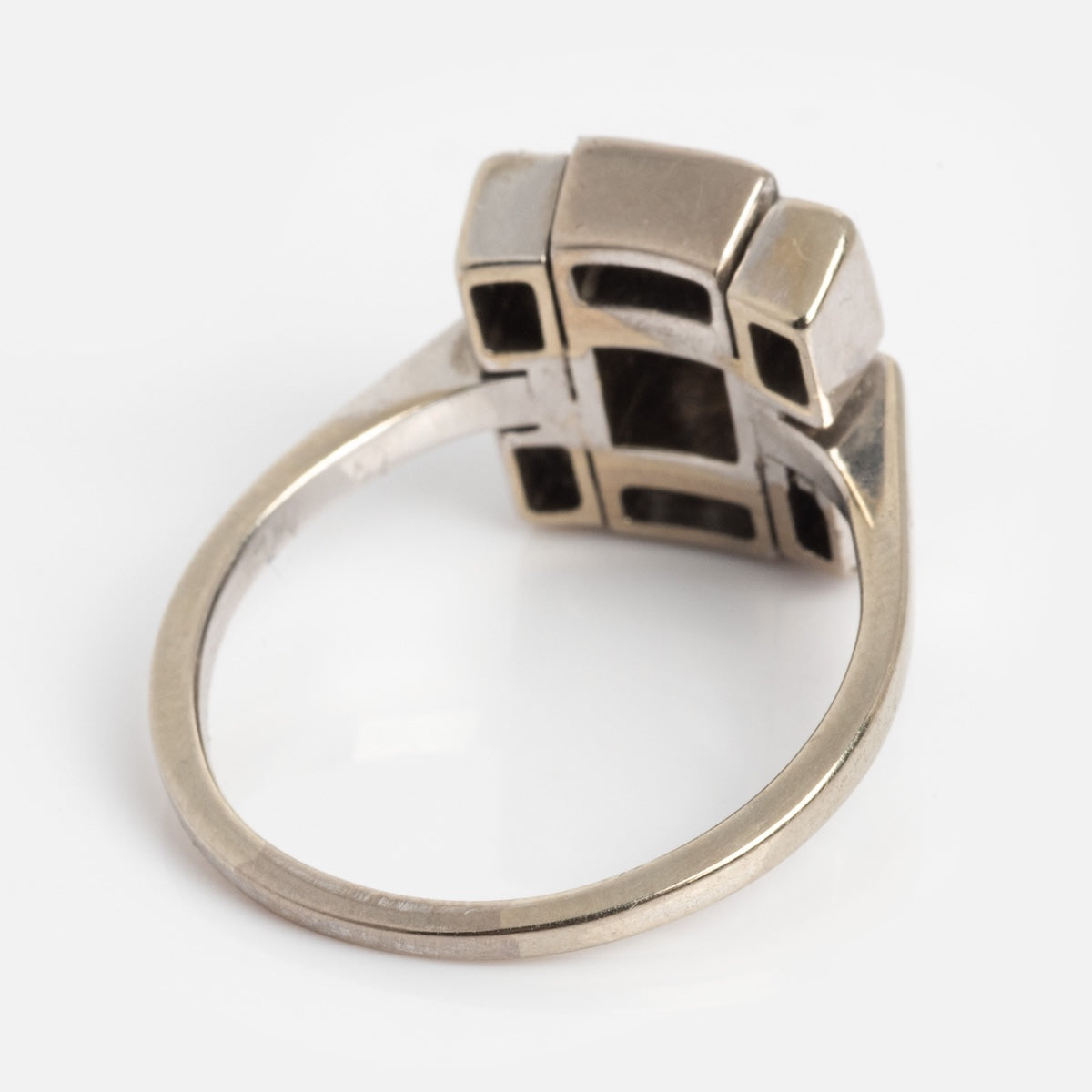 A Vintage 18k 1930s Art Deco Geometric Diamond Ring in size 9, shown at an angle highlighting the blocky design and underside of the band against a white background.