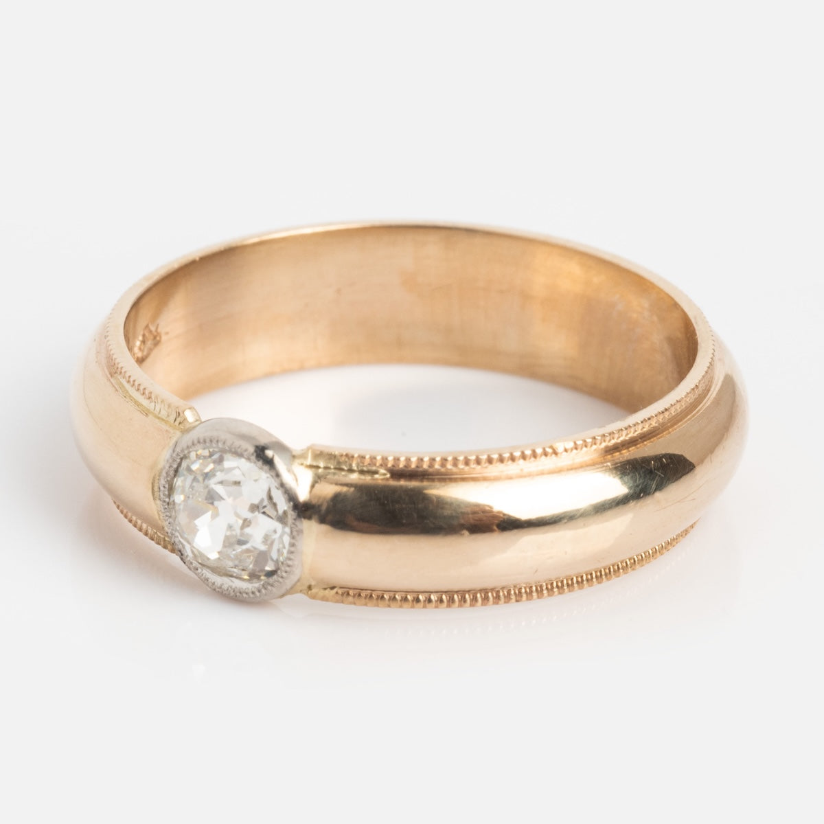 The Vintage 14k 1900s Euro Cut Diamond Classic Band, size 7.5, features a single round diamond in a bezel setting with beaded edge details, shown on a white background.