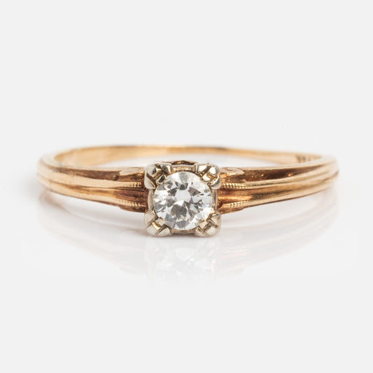 The Vintage 14k 1940s Solitaire Round Diamond Engagement Ring, size 6.5, features a round diamond in a four-prong setting on yellow gold and is displayed against a white background.