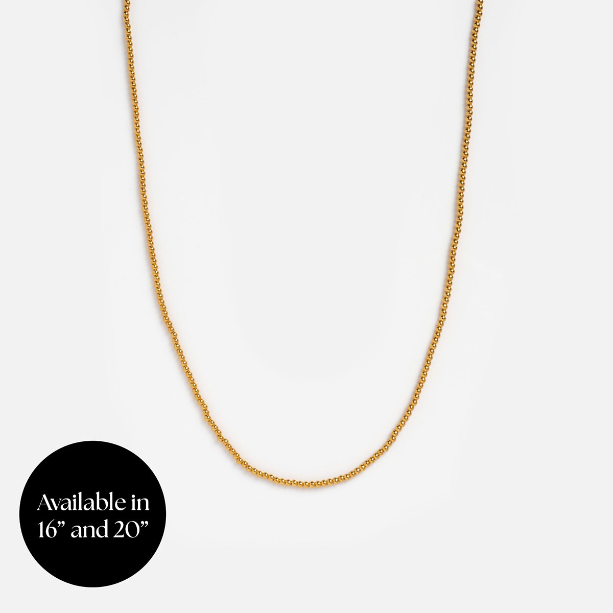 A delicate Chain For Charms in gold vermeil shown on a plain white background, with a black circle in the lower left corner stating: Available in 16” and 20”.