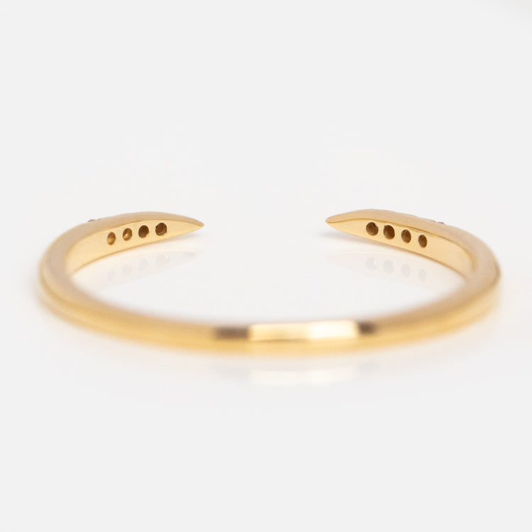 The 14k Open Front Stacking Ring is crafted from recycled gold jewelry and features open ends, each with three small circular holes, displayed on a white background.