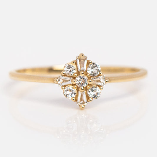 The 14k Floral Art Deco Ring features a cluster of round and baguette-cut diamonds in a floral design on a thin recycled gold band, shown against a white background.