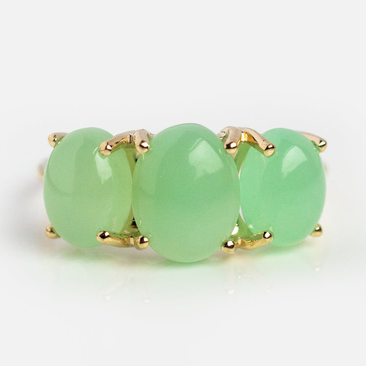 The Sweetest Gumdrop Ring features four large oval translucent green stones set in yellow gold, displayed in a row on a white background.