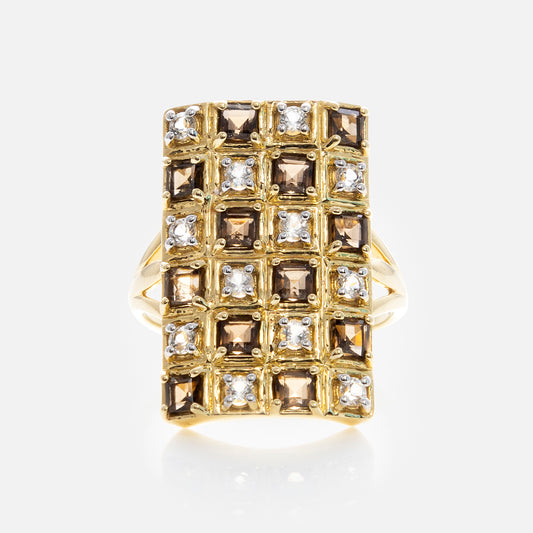 The Solid Gold Checkerboard Gemstone Shield Ring features a large rectangular face with alternating square smoky quartz and clear gemstones arranged in a striking grid pattern.