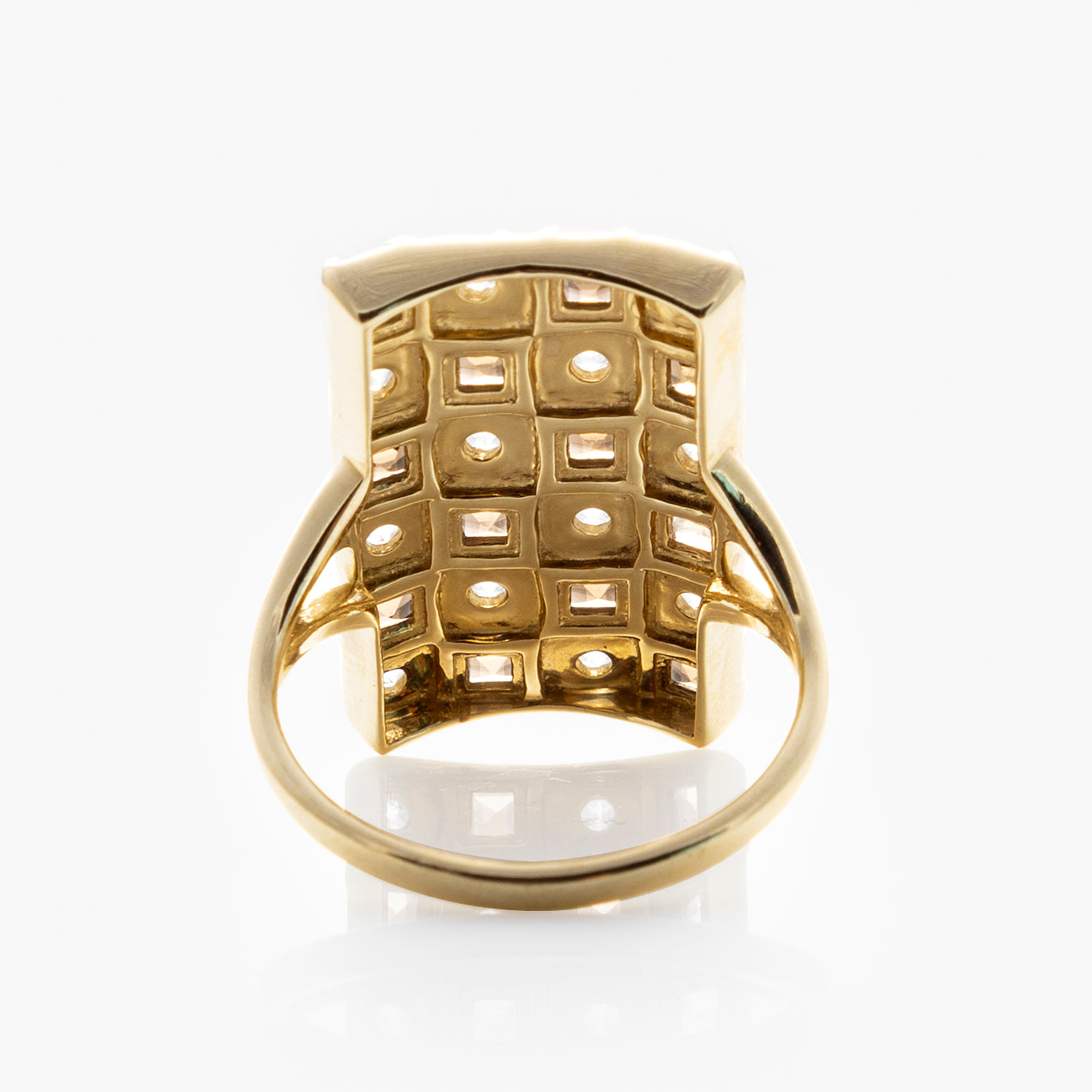 The Solid Gold Checkerboard Gemstone Shield Ring is shown bottom-up on a white background, displaying a grid of square settings—each with a center hole—designed to hold gemstones, resembling a checkerboard pattern.