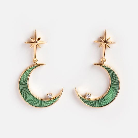Elegant and celestial, the La Lune Teal Green Earrings feature crescent moon shapes in green enamel, each topped with a small star and accented with a sparkling cubic zirconia near the tip.