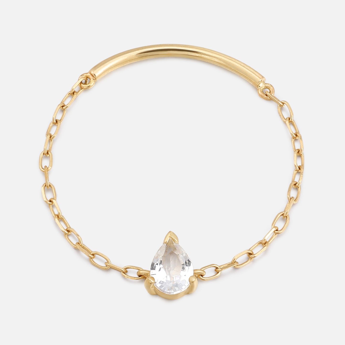 The Solid Gold White Topaz Pear Chain Ring features a delicate gold band with a curved bar and a pear-shaped white topaz centerpiece, echoing the elegance of fine chain bracelet designs, showcased on a simple light background.