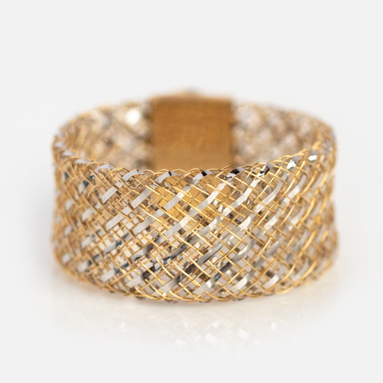 The Solid Gold Mesh Gemstone Ring features interwoven 9k yellow gold and silver strands with a turquoise stone, creating a textured mesh pattern. Shown in sample size 7 against a plain white background.