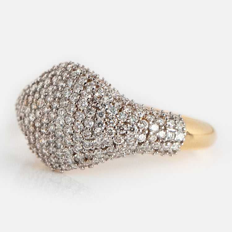 The 14k Solid Gold Pave Diamond Signet Ring features a wide, rounded top encrusted with sparkling diamonds for a textured, shimmering look—an elegant accessory for any occasion.