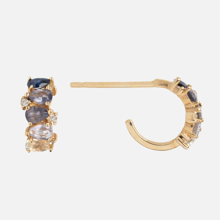 The Solid Gold Ombre Birthstone Huggie Hoops are 9k gold earrings with a row of multicolored gemstones and small diamonds, displayed from the front and side on a light background.