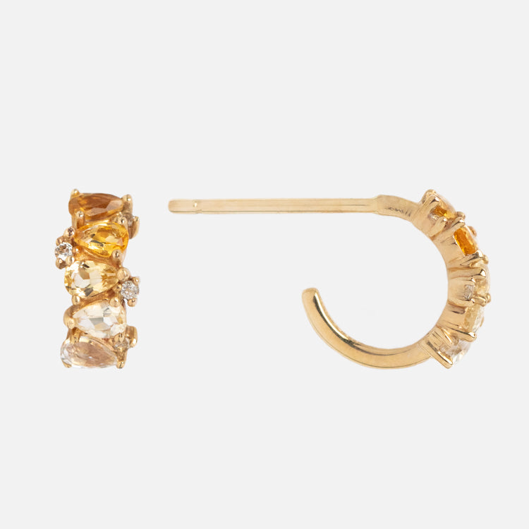 Solid Gold Ombre Birthstone Huggie Hoops in gold, adorned with clusters of yellow, orange, and clear gemstones, shown against a plain white background.