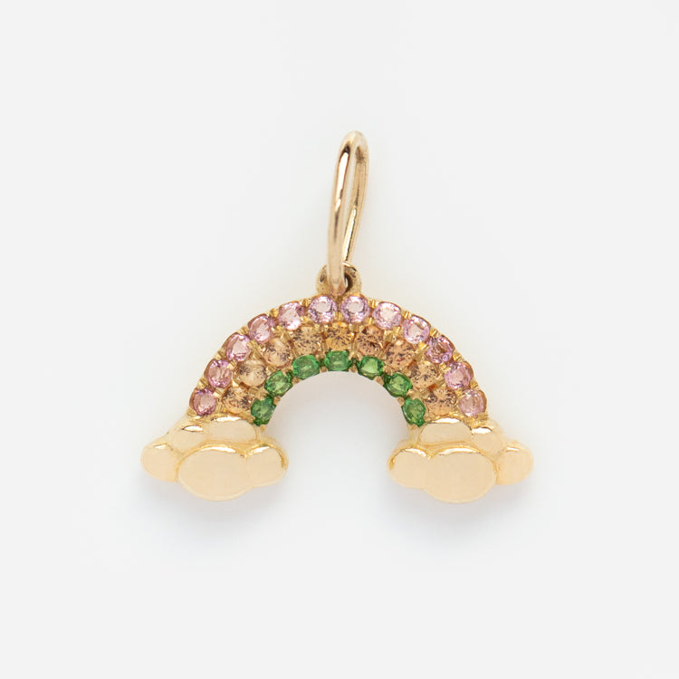 The Solid Gold Nature Charm features a rainbow with two clouds at each end, adorned with pink and green gemstones along the arch, adding whimsical sparkle against a plain white background.