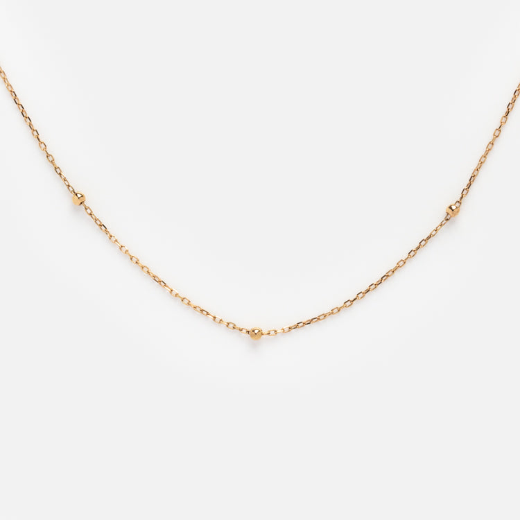 Solid Gold Chain for Charms features a delicate design with small, evenly spaced bead accents, shown on a plain white background.