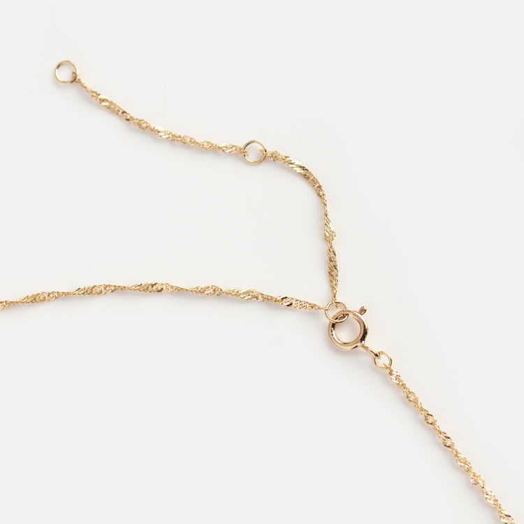 The Solid Gold Twisted Chain Necklace, designed in the classic Singapore style, features a small spring ring clasp with extra open loops for adjustable sizing, shown close-up against a white background.