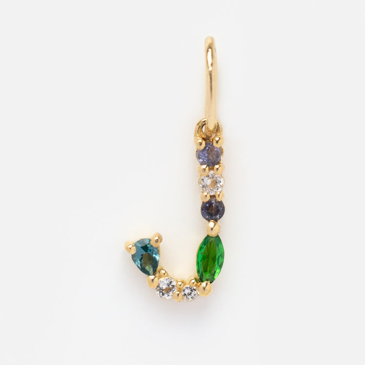 Solid Gold Gemstone Letter Charm shaped like the letter J, featuring small round and marquise-cut green, blue, and clear stones—a dazzling accessory displayed on a white background.