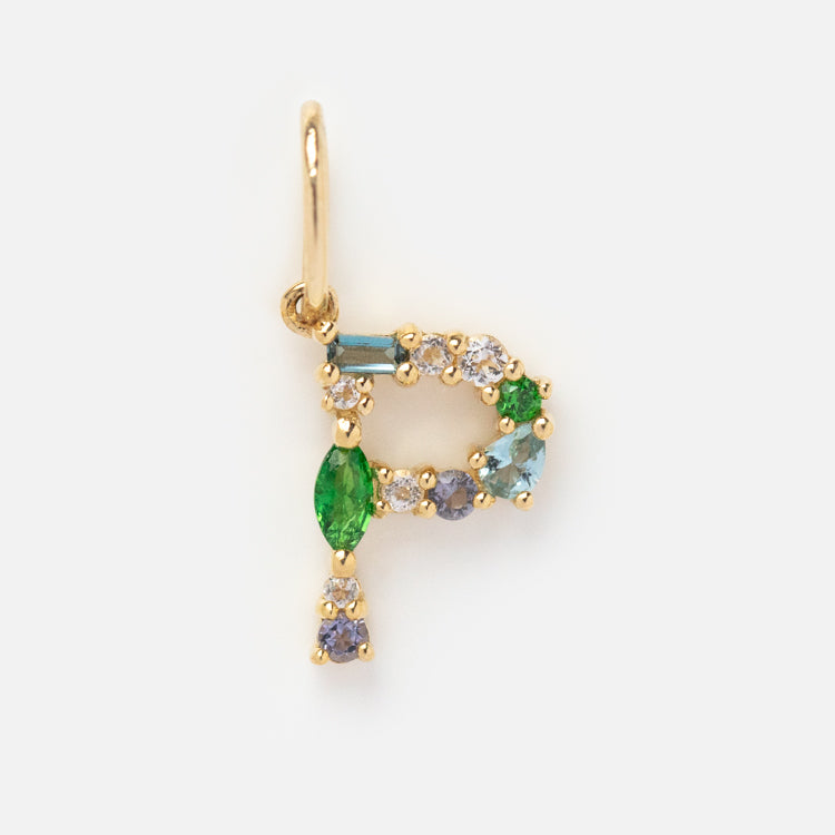 The Solid Gold Gemstone Letter Charm is shaped like a “P” and features multicolored gemstones in green, blue, white, and purple, shown on a plain white background.