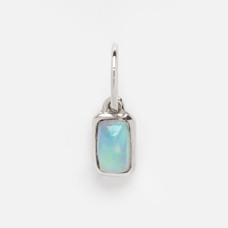 A solid gold birthstone baguette charm in white gold with a sleek, modern design—displayed on a plain white background and perfect for adding a personalized touch to any jewelry collection.