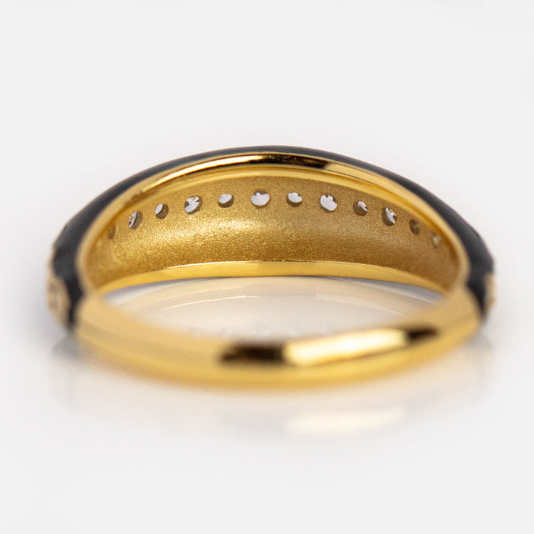 A close-up view of the inside of the Free Spirit Black Enamel Ring reveals small circular holes along the gold-plated inner band and a smooth, shiny surface, showcasing its intricate craftsmanship. This is a Local Eclectic exclusive.