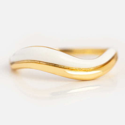 The Summer Breeze Enamel Wave Ring features a smooth, wavy design in 14k yellow gold plating with a glossy white enamel accent on the upper curve, shown against a plain white background.
