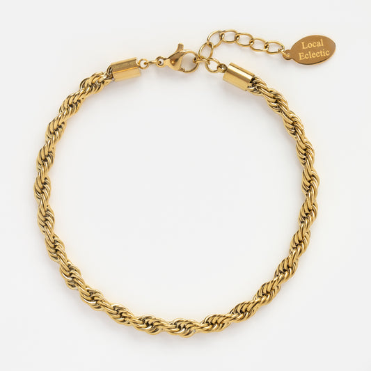 The Bold Rope Chain Bracelet features a twisted gold rope design, lobster clasp, extender chain, and a small oval tag engraved with Local Eclectic. Shown on a white background.