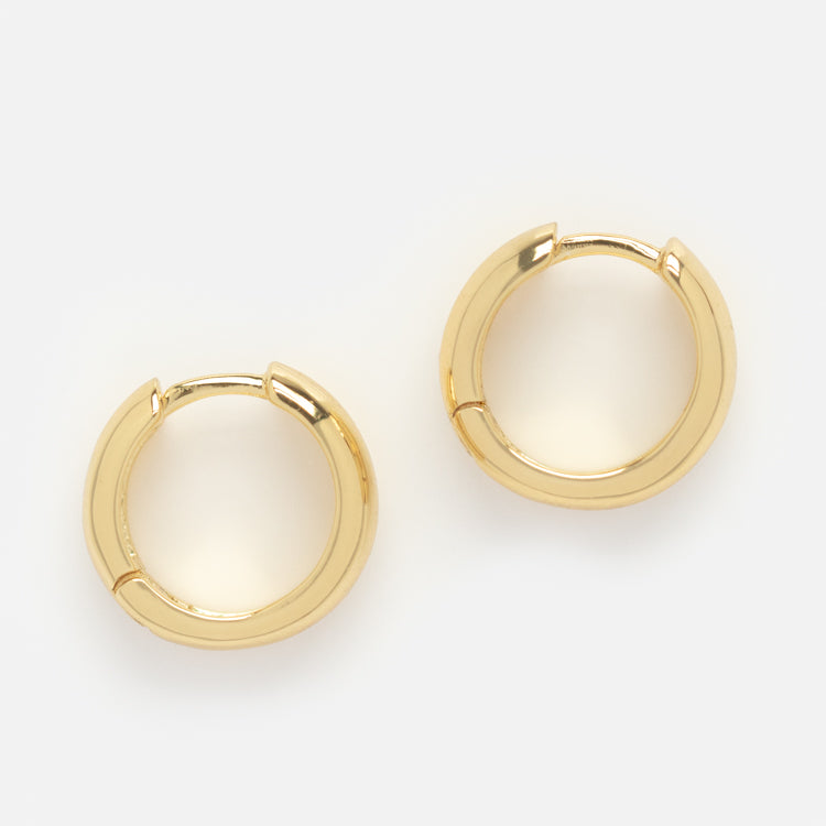 A pair of Chunky Huggie Hoops in classic gold, ideal for stackable jewelry styles, shown against a plain white background.