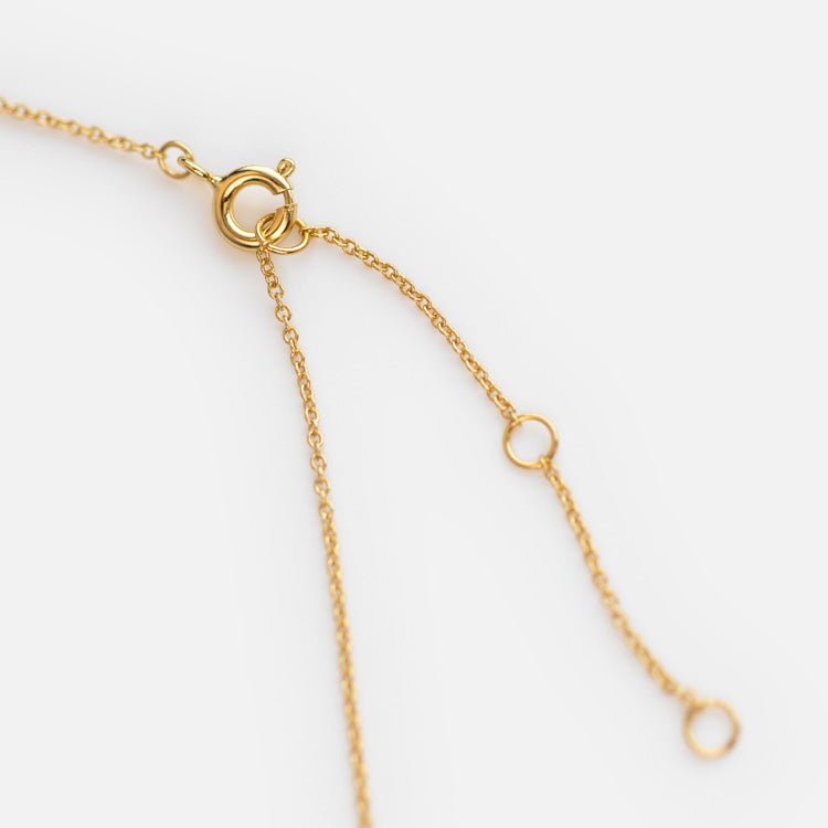 Close-up of the Nightfall Tourmaline Pendant Necklace’s 14k gold vermeil clasp with a spring ring closure and two fine chain ends, each finished with a small circular ring, shown on a white background.