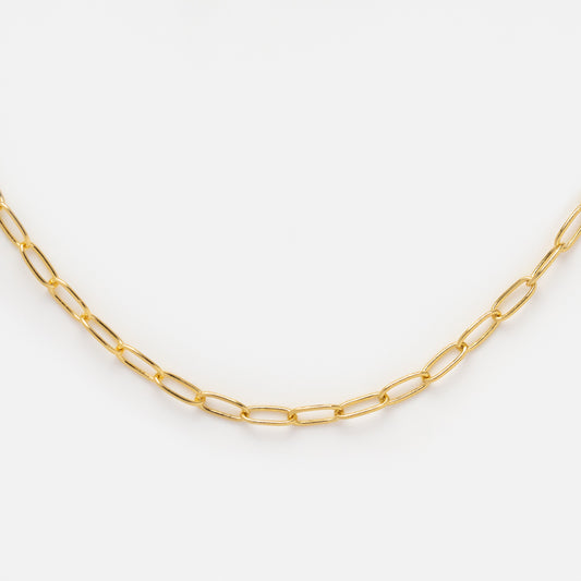 The Vermeil Paperclip Necklace features delicate elongated gold oval links, ideal for layering, and is shown on a white background.