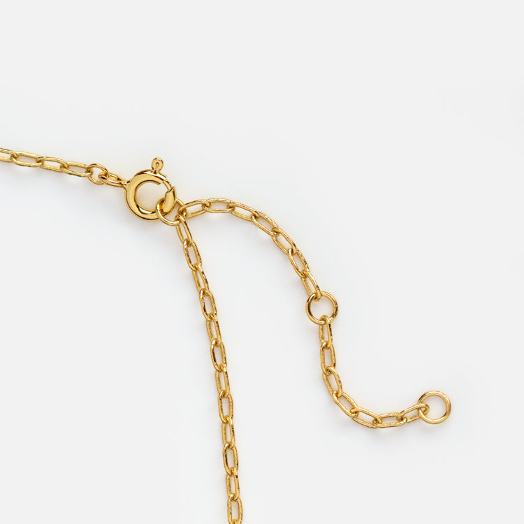 Close-up of the Bubble Letter Necklace, a 14k gold plated piece featuring a spring ring clasp and adjustable links, displayed on a white background.