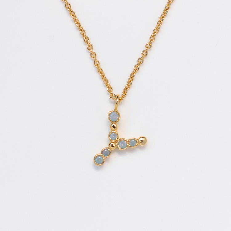The Initial Charm Necklace Sample is a 14k yellow gold plated brass chain with a Y-shaped pendant, each segment adorned with opalescent nano gems, shown on a plain white background.