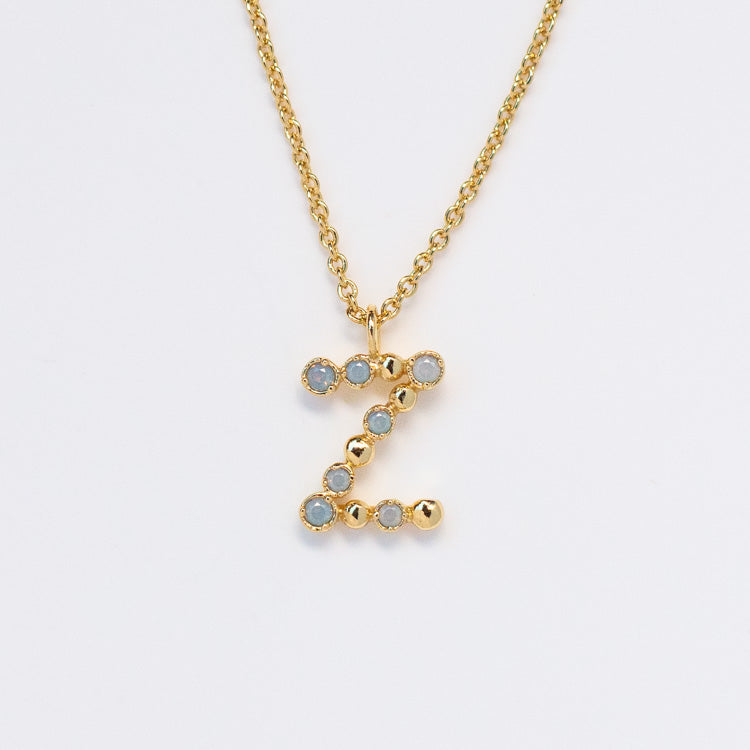 Initial Charm Necklace Sample featuring a Z-shaped pendant, crafted with opalescent nano gems and gold beads on a brass base, 14k yellow gold plated, displayed against a plain white background.