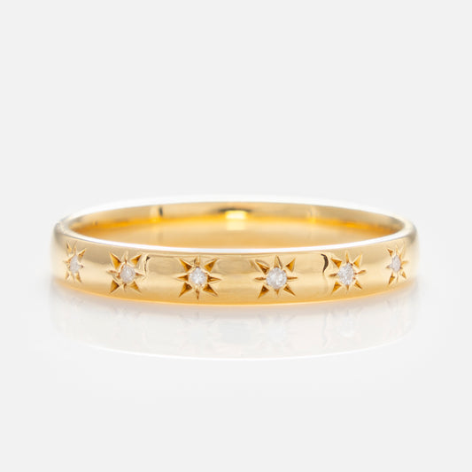 The Simple Star Set Diamond Band is a yellow gold vermeil pinky ring with small round diamonds set in star-shaped engravings around the band, shown on a plain white background.