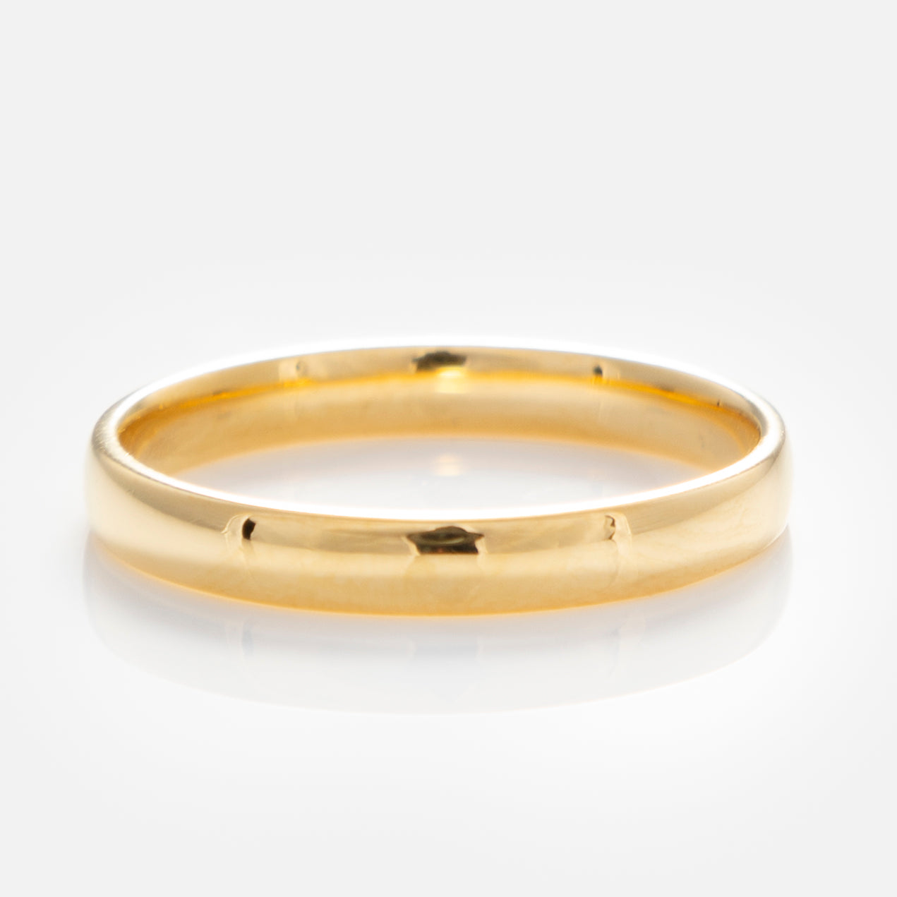 The Simple Star Set Diamond Band, crafted in polished yellow gold vermeil with a smooth, shiny surface and sparkling diamonds, is displayed on a white background reflecting light.