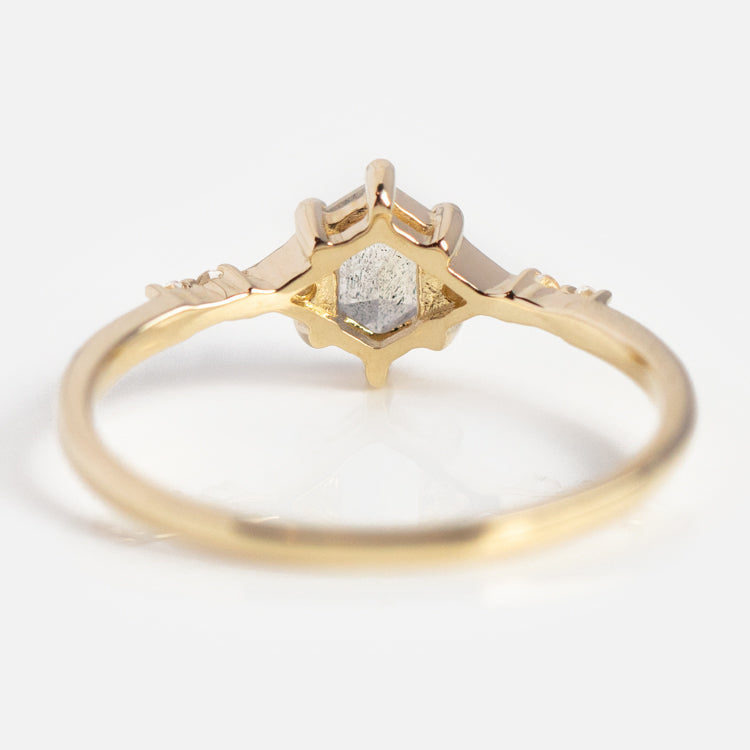 The Solid Gold Mystic Labradorite Hexagon Ring for Protection features a geometric hexagonal labradorite stone at its center, set in a unique pointed crown design on a smooth, delicate solid yellow gold band.