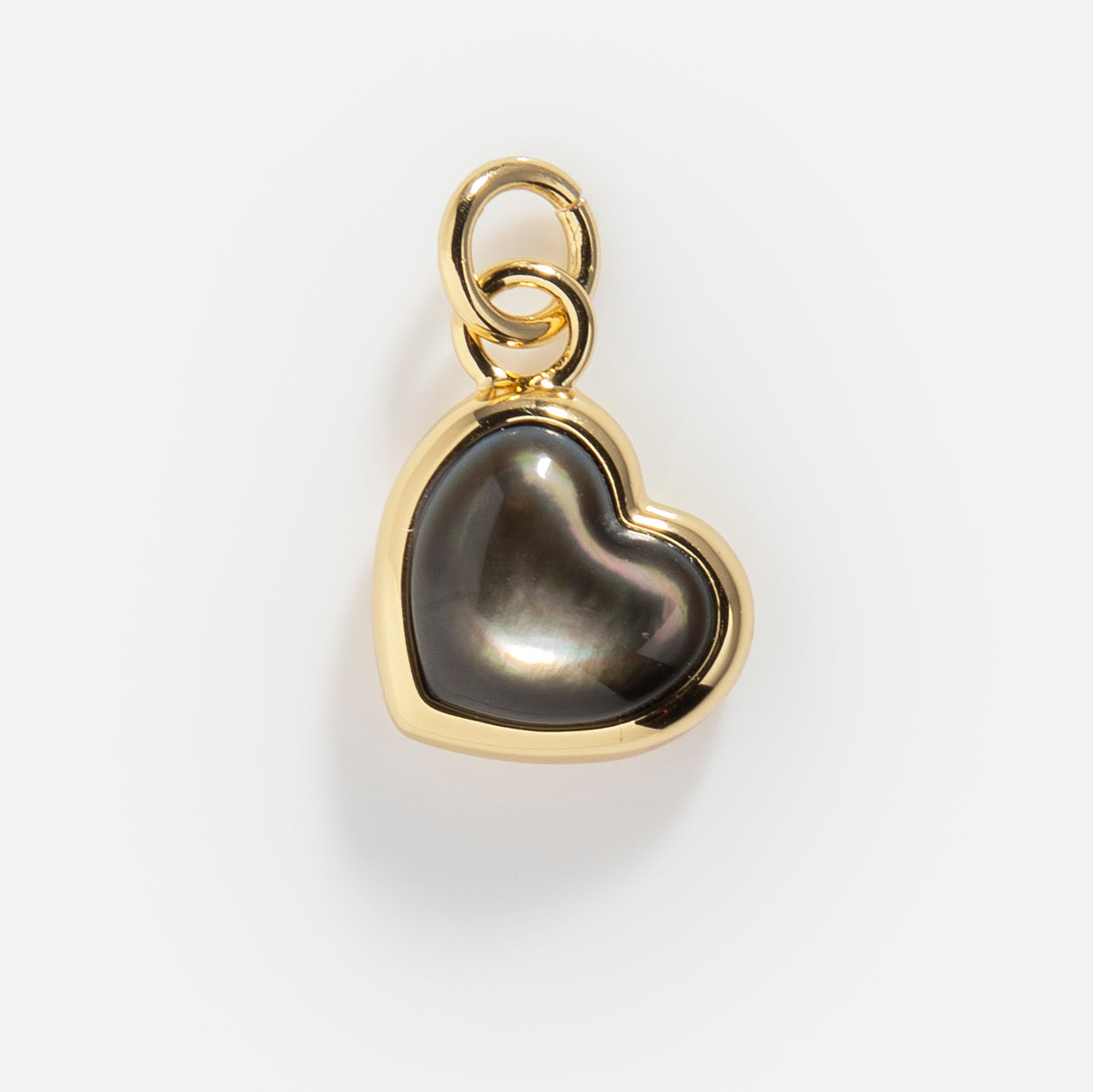 Charms by Elizabeth Stone: A 14k gold plated heart-shaped pendant featuring a dark, iridescent mother of pearl center and polished finish, shown on a plain white background with a gold loop for wearing on a chain.