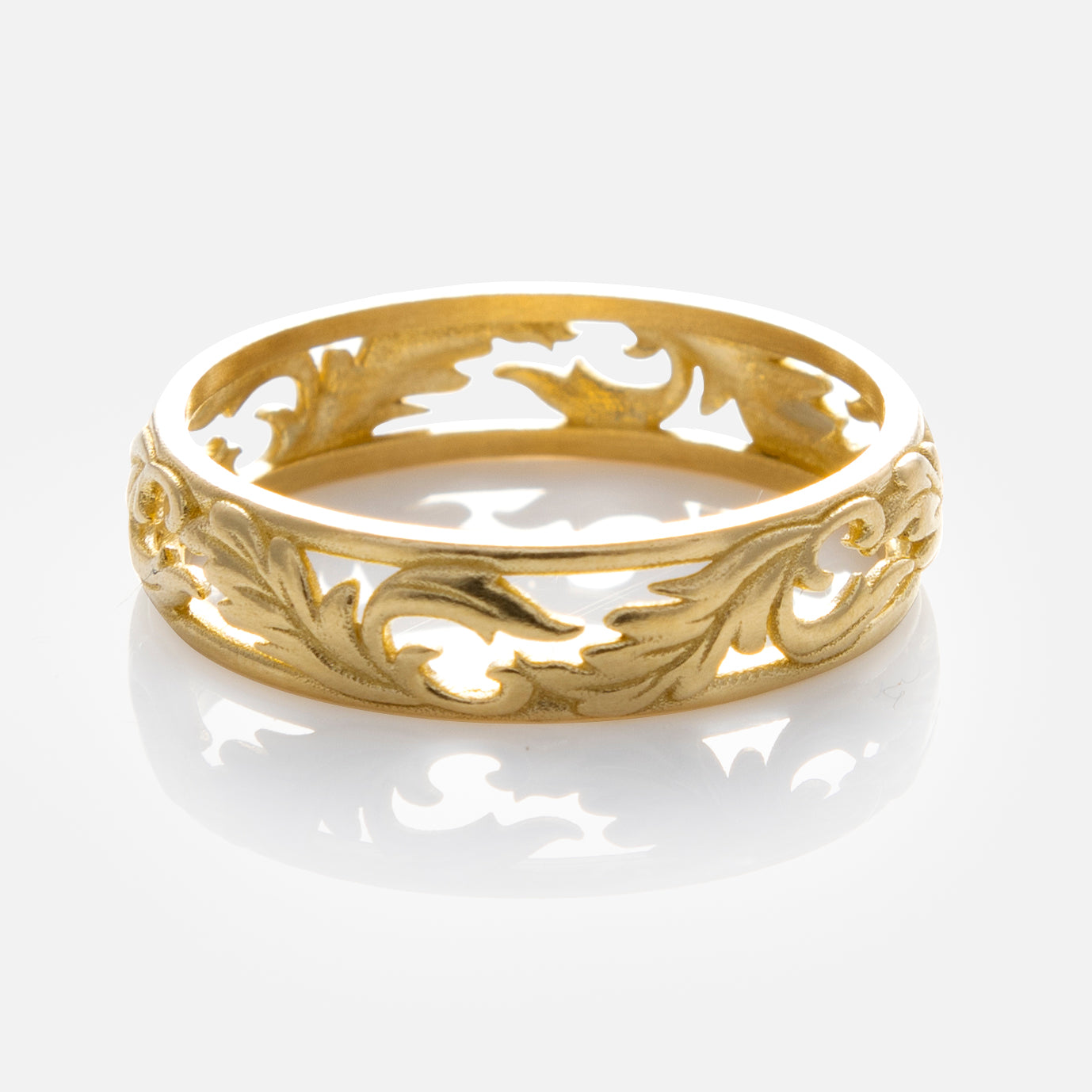 The Solid Gold Openwork Filigree Ring features intricate leaf and vine patterns in a vintage-inspired design, shown on a white background with a subtle reflection.
